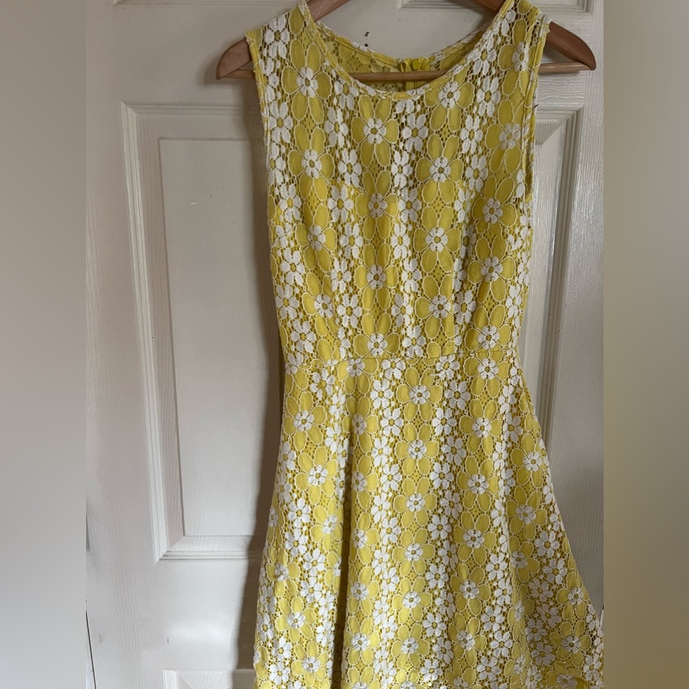 I am selling a yellow and white lace size 6 dress for $20.